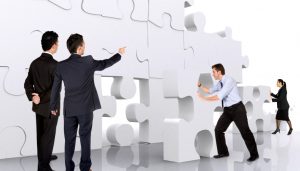 business teamwork - business men making a puzzle